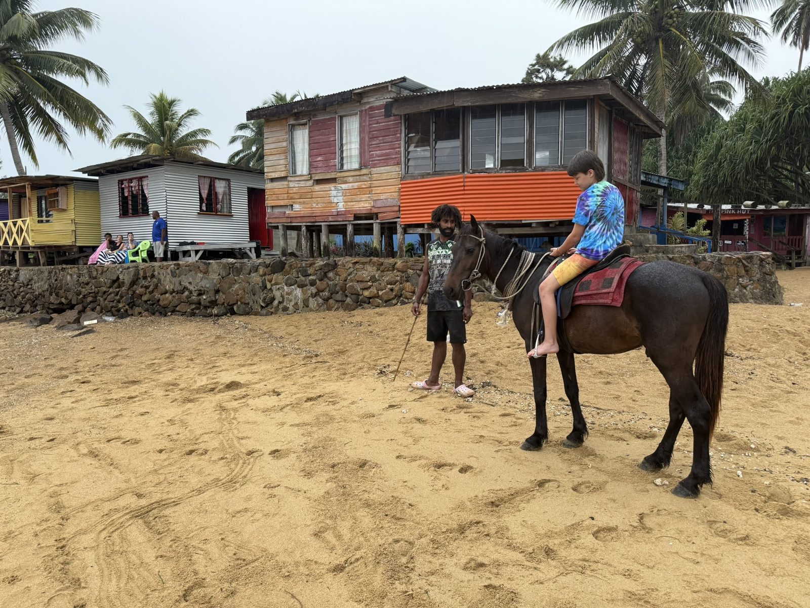 Kid on horse in the village with guide